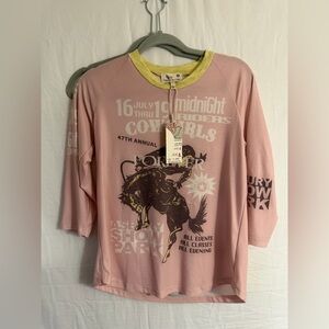 Pink graphic t-shirt with a vintage-style rodeo print.